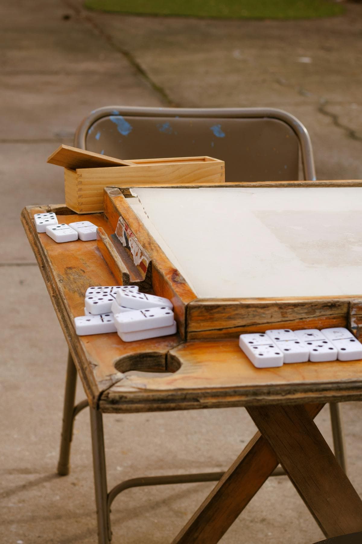 Close-up of dominoes game on an outdoor table at a colmado
